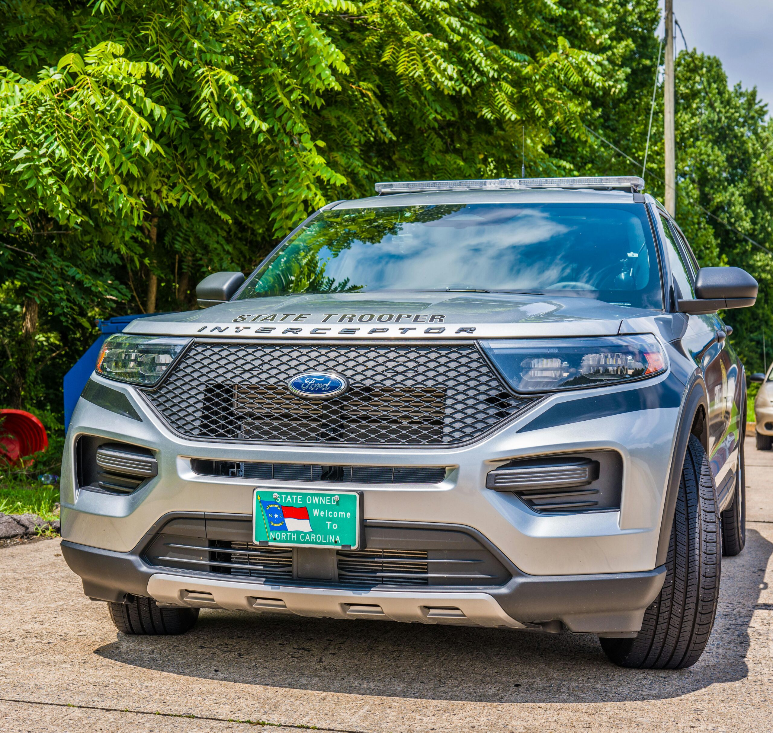 the front grill of a North Carolina state trooper SUV - silver and black with the ford logo