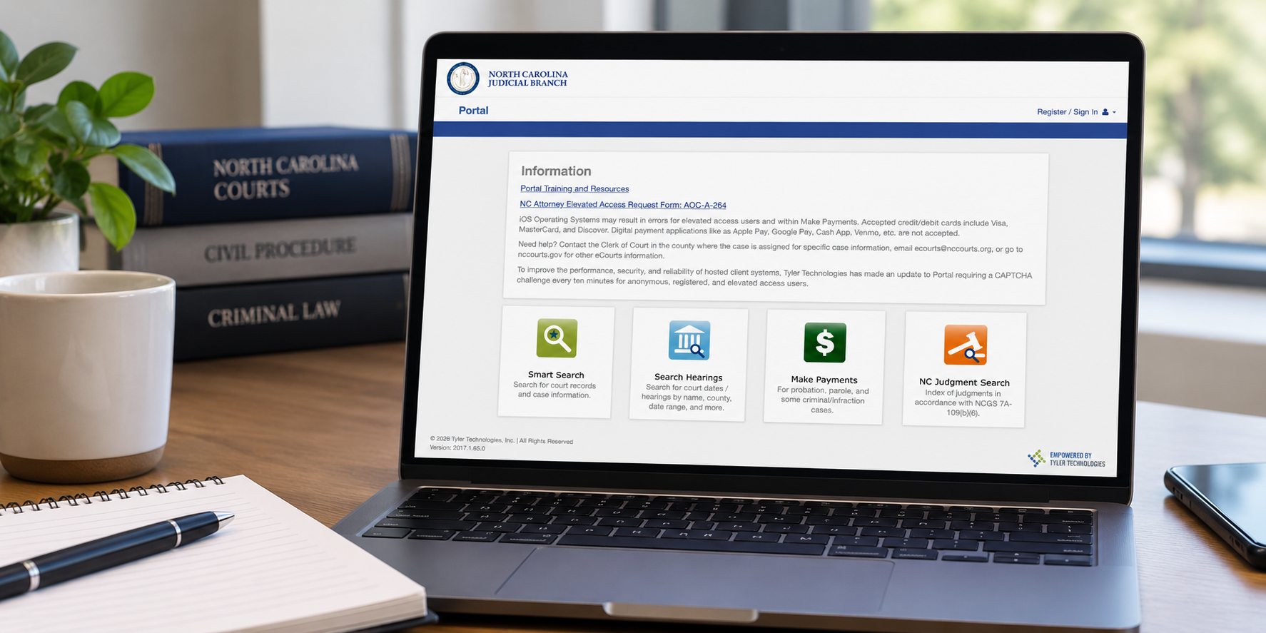 Laptop displaying the North Carolina Courts Portal Smart Search page used to search public court records and case information.